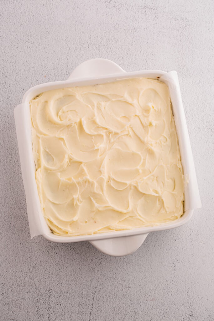 Square pan of banana brownies spread with cream cheese frosting