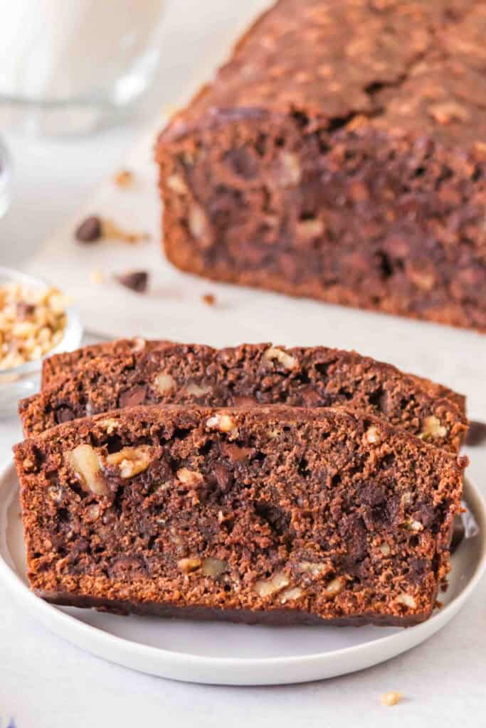 Close up of sliced brownie banana bread showing chocolate chips and walnuts inside.