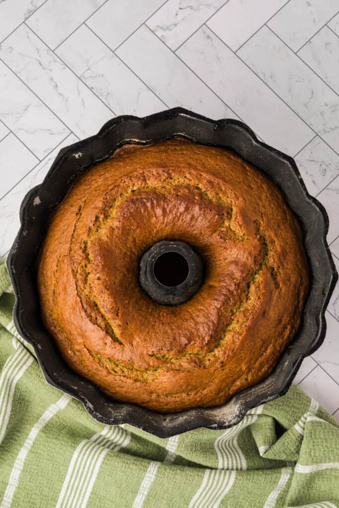 baked pistachio bundt cake cooling in the pan