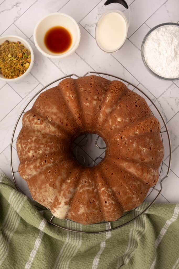 pistachio bundt cake removed from the pan and cooling on a wire rack