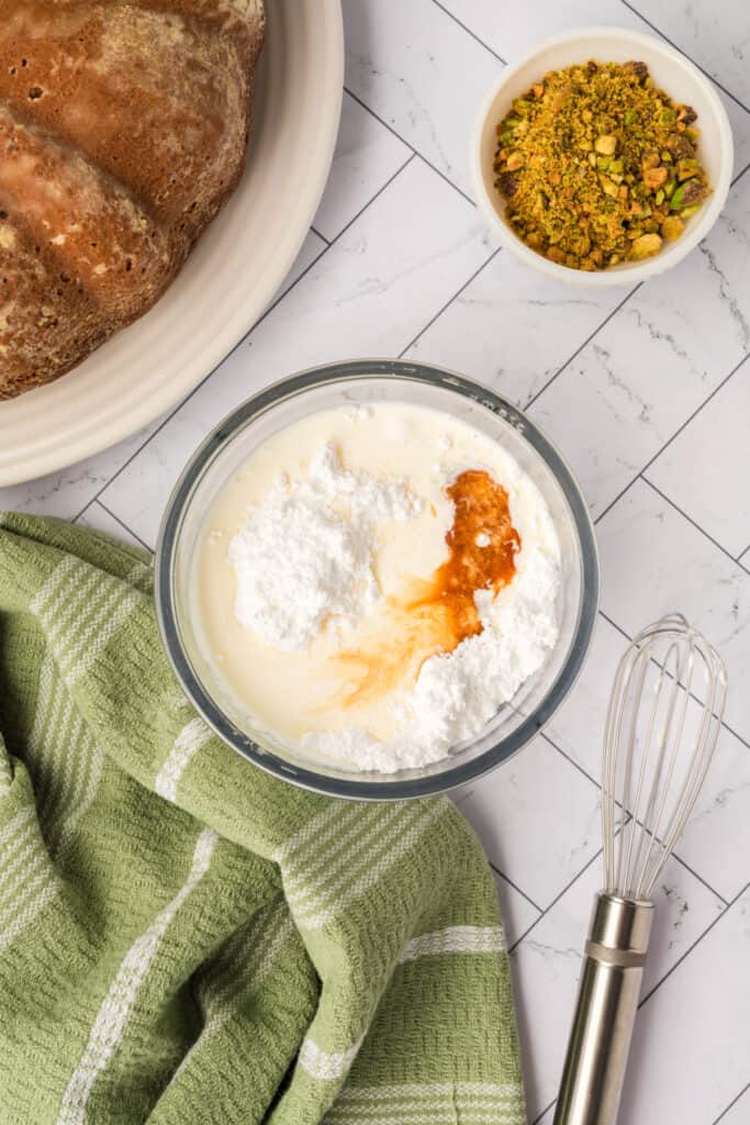 bowl with powdered sugar, heavy cream, and extract before mixing glaze