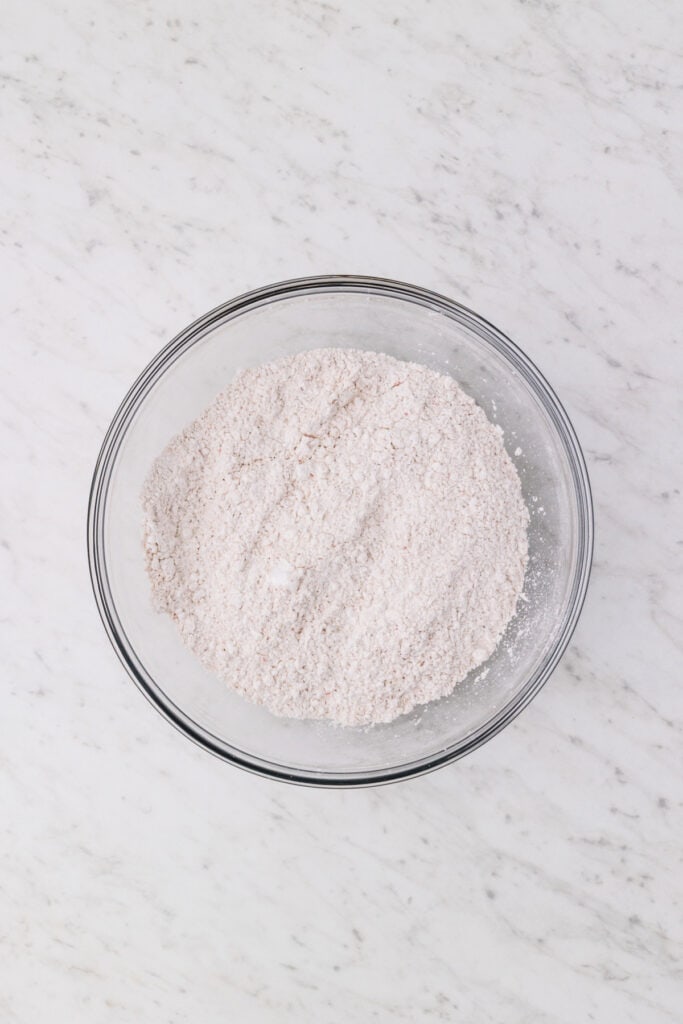combined powdered sugar mixture with carrot cake mix and spices in a bowl