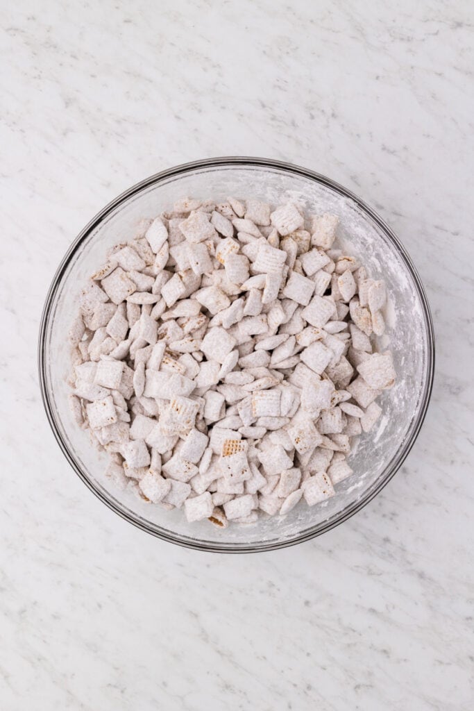 cereal coated in powdered sugar mixture in a large bowl