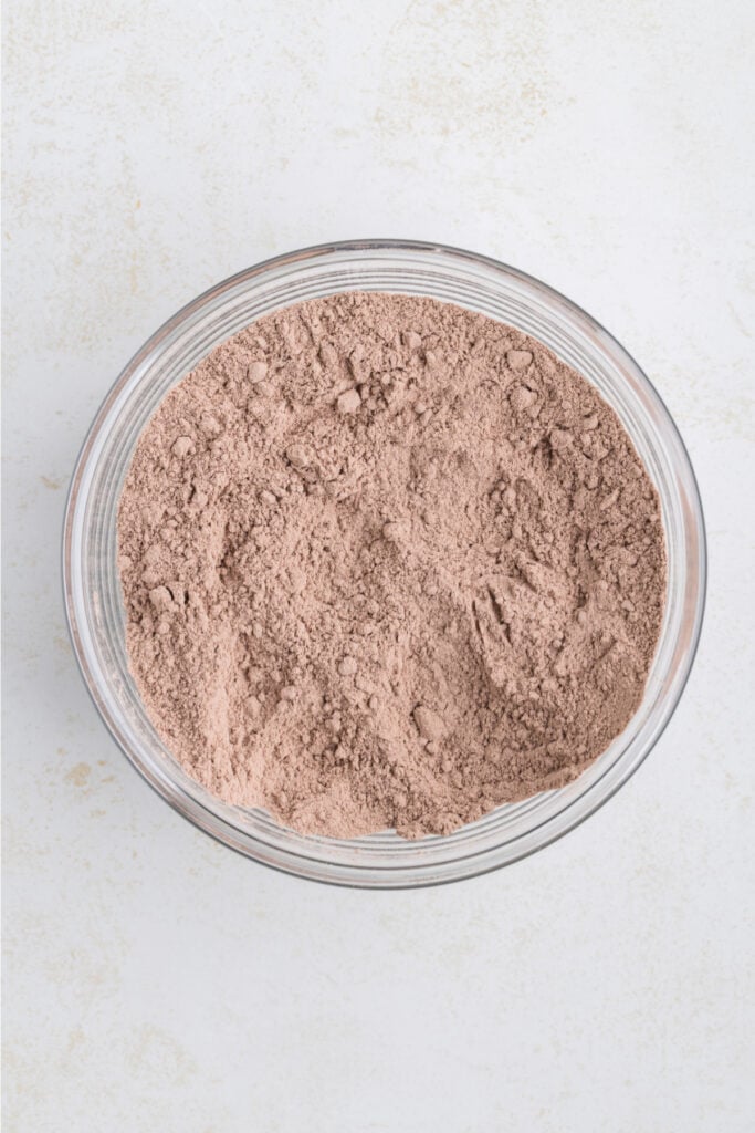 glass bowl with chocolate brownie mix and flour combined