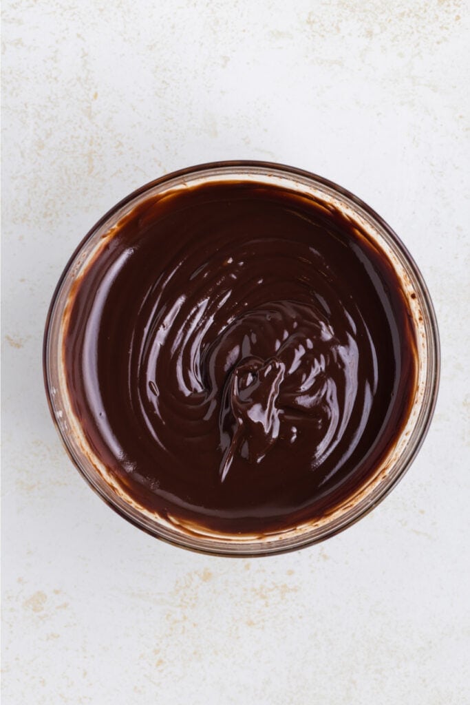 smooth chocolate ganache in a glass bowl