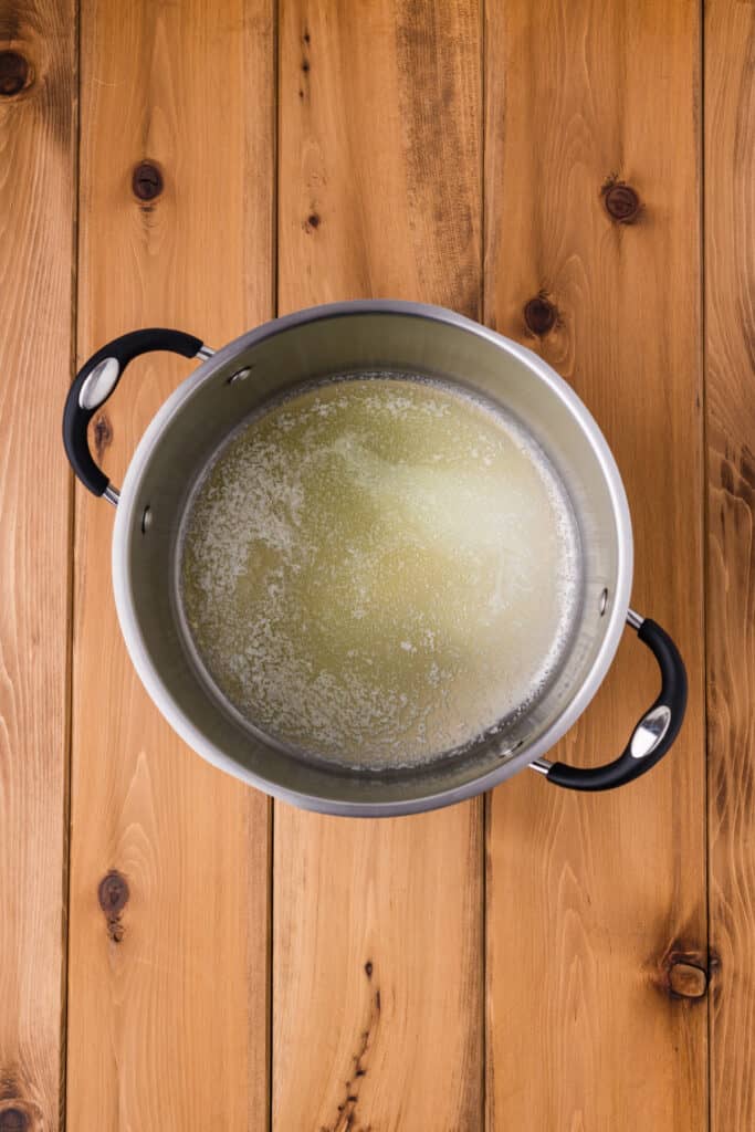melted butter in a large saucepan on a wooden surface