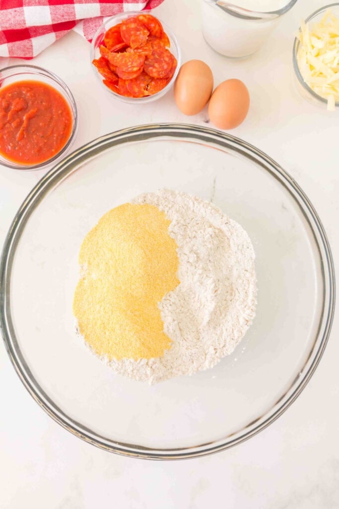 flour and cornmeal added together in a large glass mixing bowl