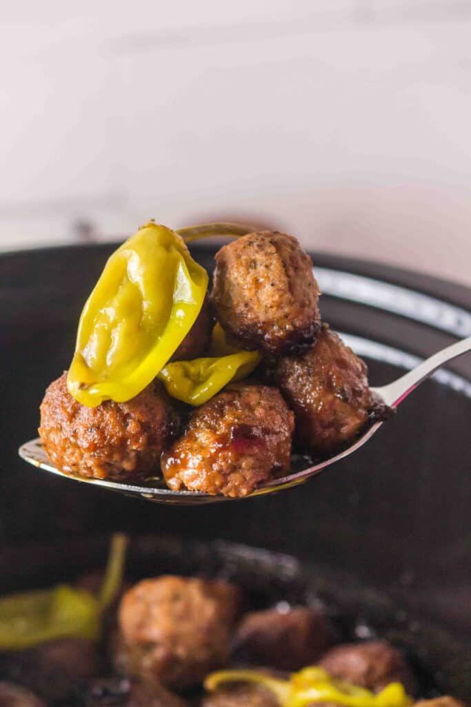 slow cooker mississippi meatballs served over mashed potatoes with pepperoncini peppers