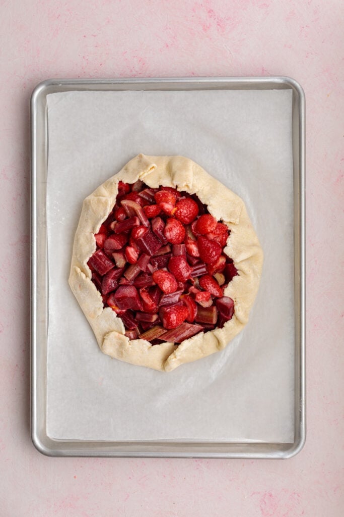galette dough folded over strawberry and rhubarb filling to form a rustic crust