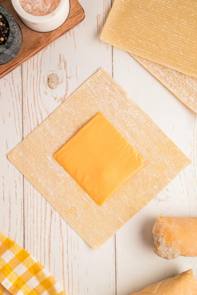 slice of American cheese placed on egg roll wrapper for Big Mac Egg Rolls assembly