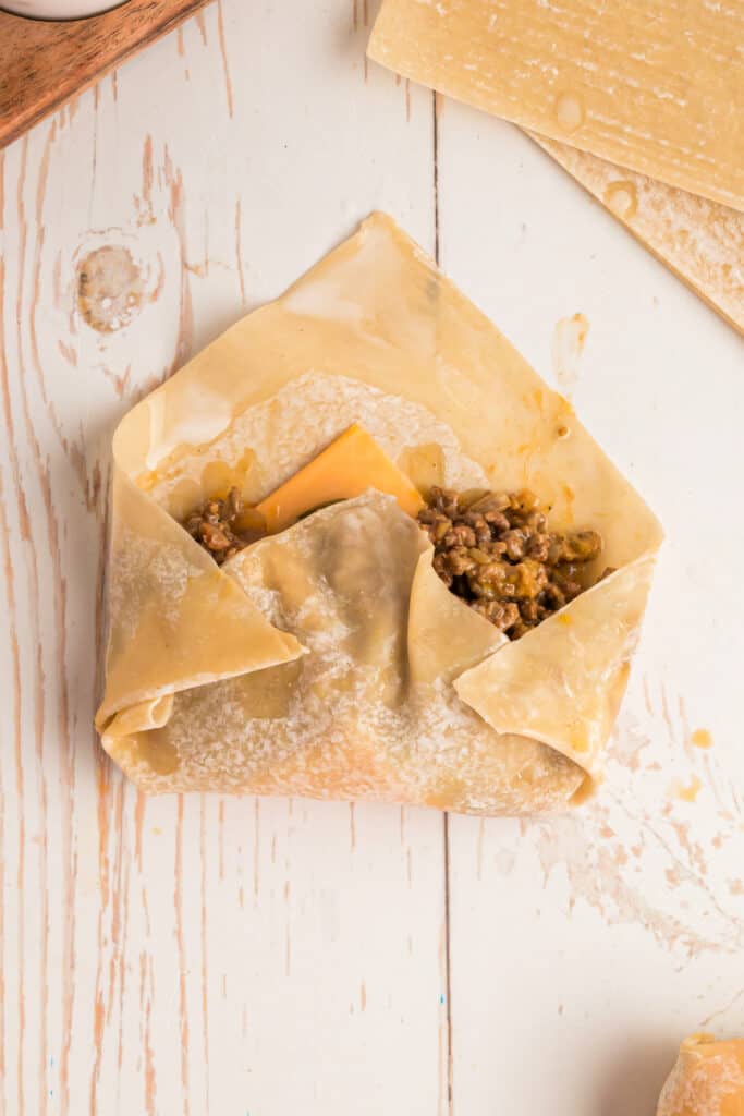 egg roll wrapper folded in with sides tucked for Big Mac Egg Rolls assembly