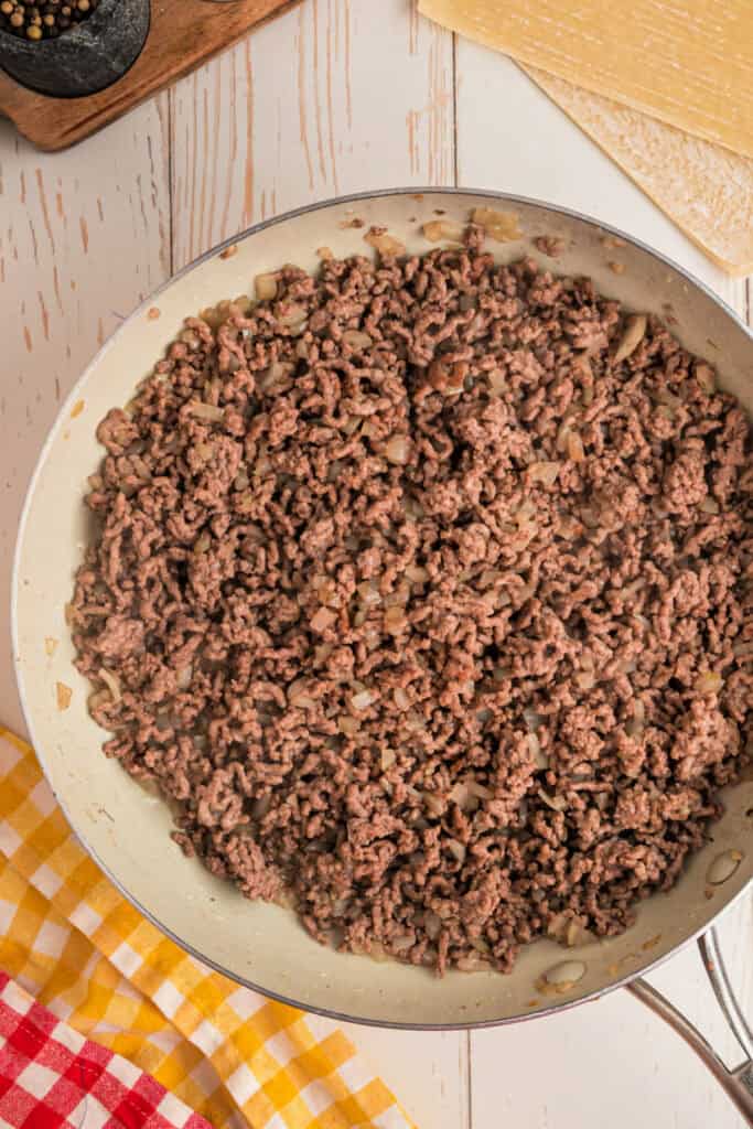 cooked ground beef and onion mixture in a skillet for Big Mac Egg Rolls