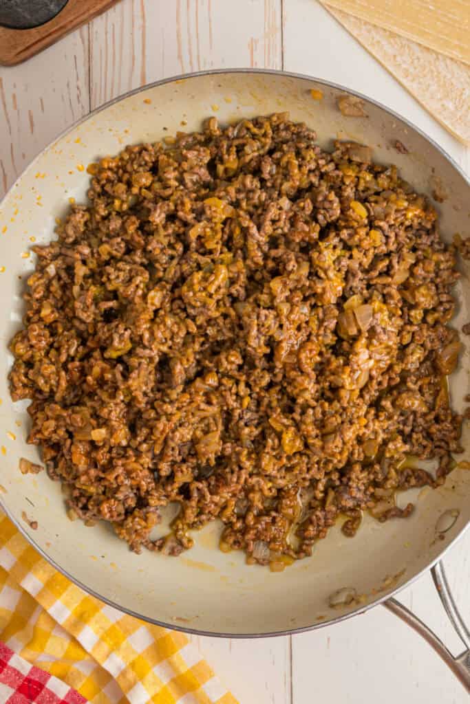 seasoned ground beef mixture fully combined in skillet for Big Mac Egg Rolls