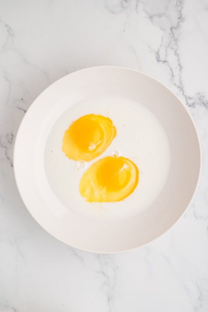 eggs and milk in a bowl before mixing