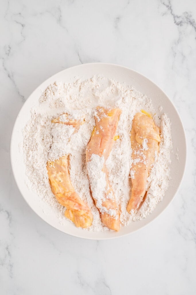 chicken strips coated again in flour after egg mixture