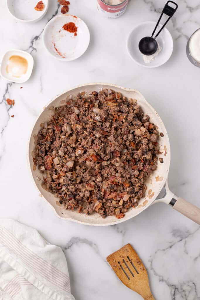 seasoned ground beef mixture cooking in a skillet for hamburger stroganoff sloppy joes