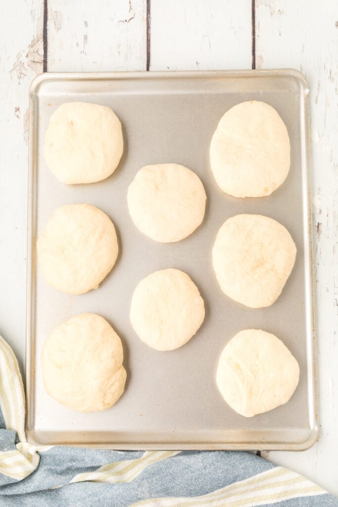 shaped homemade onion rolls dough on a baking sheet before rising