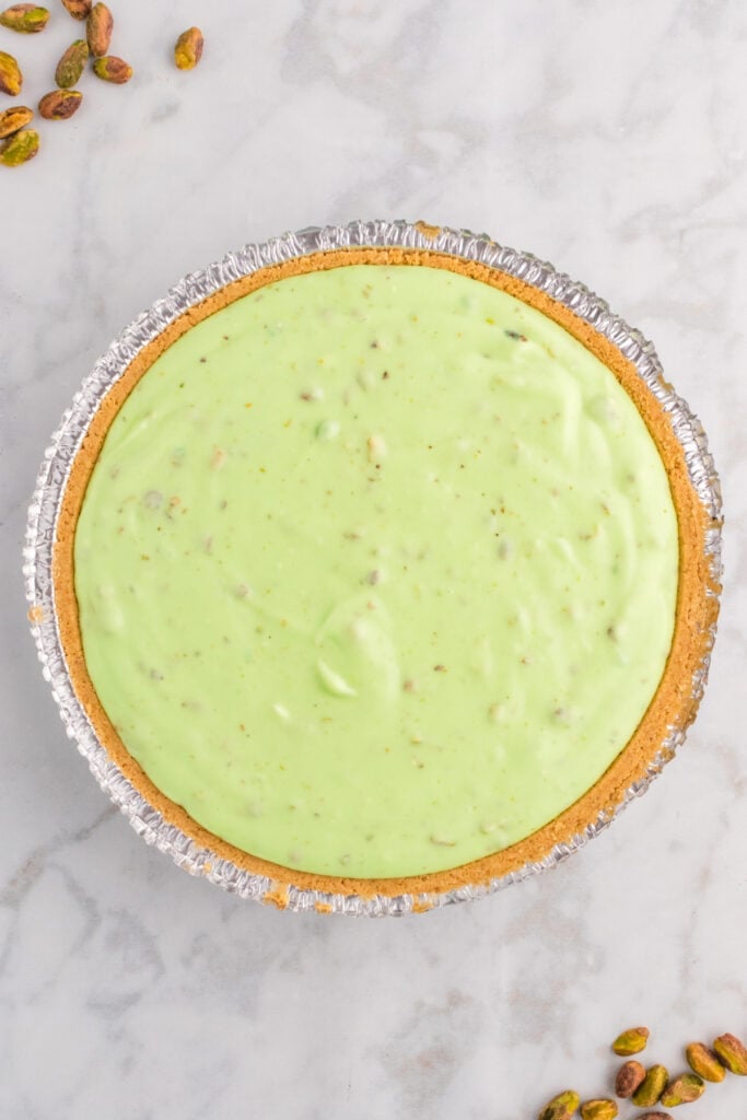 pistachio pie filling spread evenly into graham cracker crust before chilling
