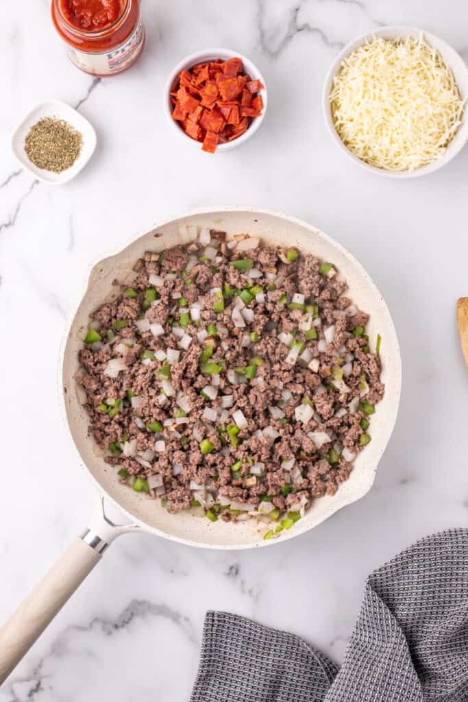 cooked ground beef mixture with onions, green pepper, and mushrooms in a skillet for Pizza Sloppy Joes