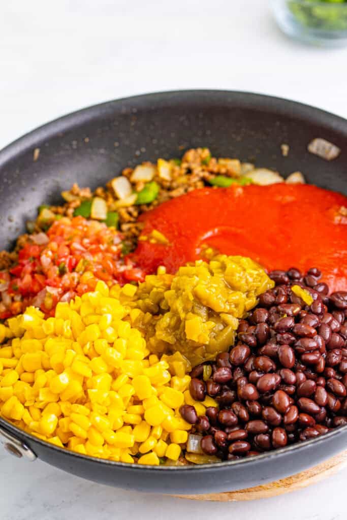 black beans, corn, salsa, green chiles, and tomato sauce added to skillet for Taco Sloppy Joes