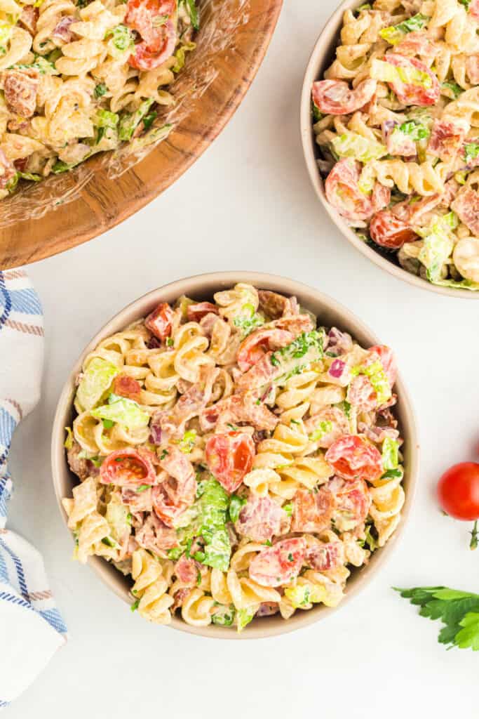 BBQ Ranch BLT Pasta Salad served in bowls showing rotini pasta, bacon, lettuce, tomatoes, and creamy BBQ ranch dressing