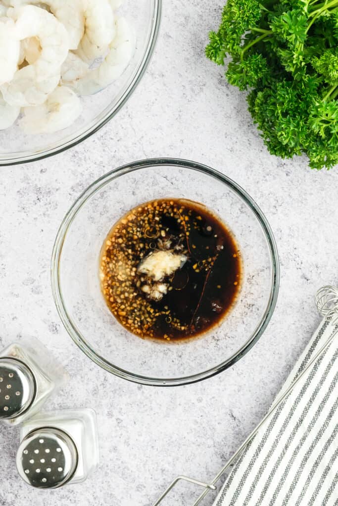 Soy sauce, sesame oil, garlic, ginger, and brown sugar combined in a glass bowl to make Hibachi Shrimp marinade.