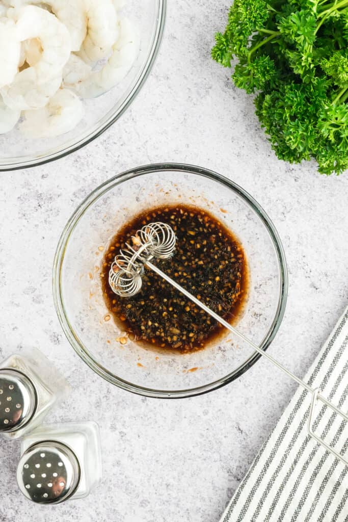 Hibachi Shrimp marinade being whisked together in a glass mixing bowl.