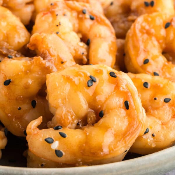 Close-up of Hibachi Shrimp coated in garlic butter sauce and sprinkled with black sesame seeds.