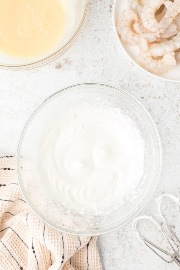 Whipped egg white batter prepared for crispy Honey Walnut Shrimp