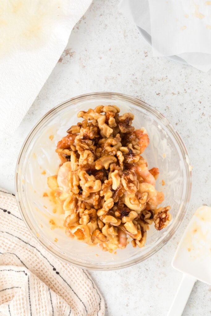 Honey Walnut Shrimp topped with candied walnuts in a glass bowl