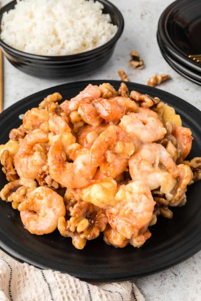 Honey Walnut Shrimp served on a black plate with white rice