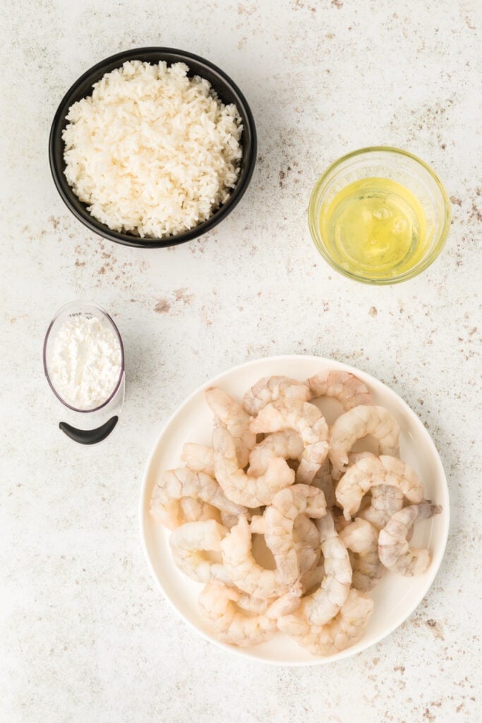 Raw shrimp, egg whites, cornstarch, and rice prepared for Honey Walnut Shrimp recipe