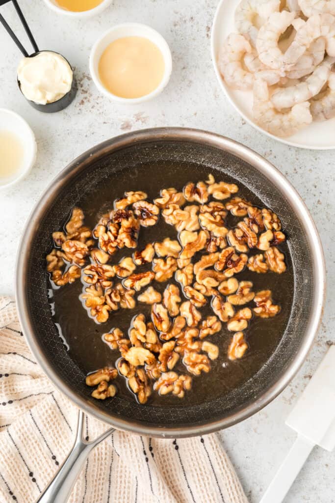 Candied walnuts simmering in syrup for Honey Walnut Shrimp recipe