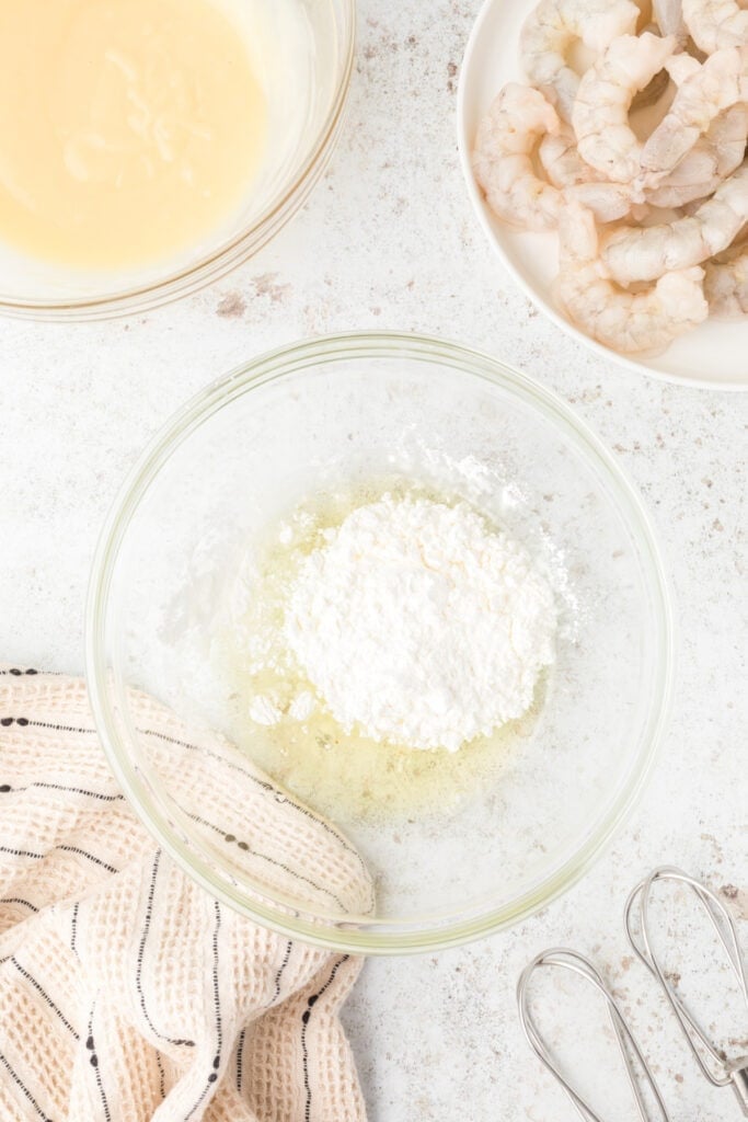 Egg whites and cornstarch in a bowl for crispy Honey Walnut Shrimp batter