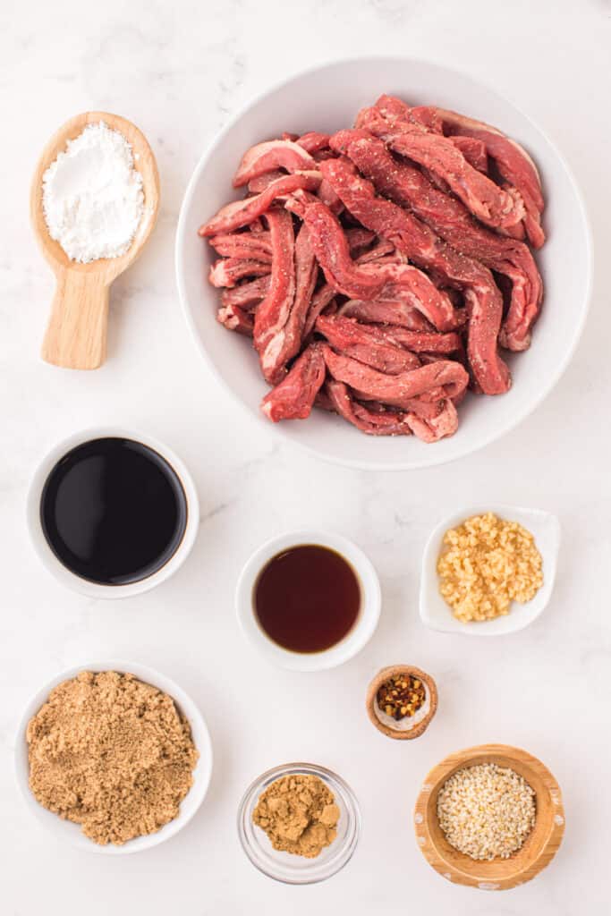 Raw sliced beef strips with soy sauce, sesame oil, brown sugar, garlic, ginger, sesame seeds, and cornstarch for Korean Beef Bulgogi