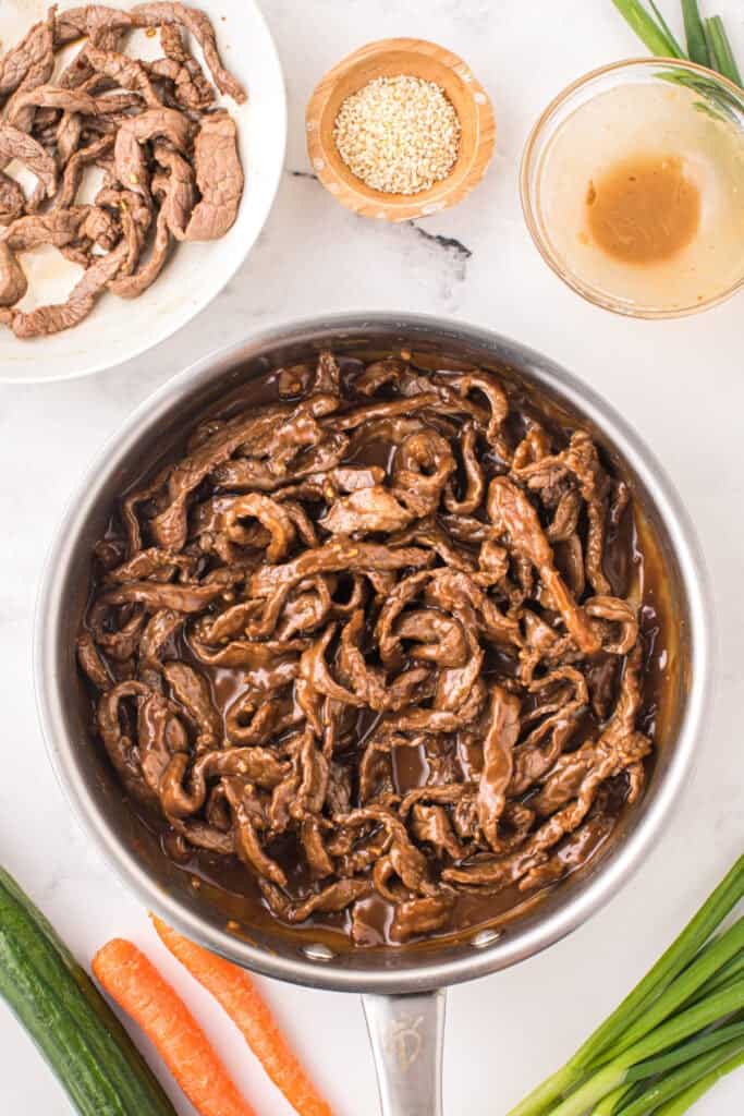 Korean Beef Bulgogi with cooked beef strips coated in thick savory bulgogi sauce in a skillet