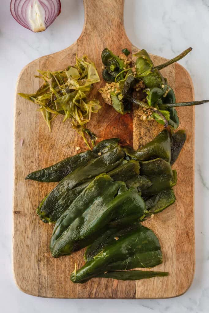 Peeled roasted poblano peppers prepared for creamy Mexican Green Spaghetti sauce