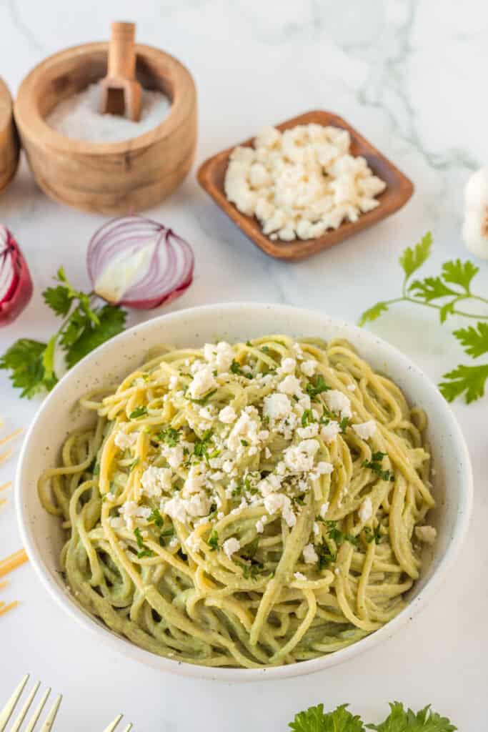 Bowl of Mexican Green Spaghetti topped with queso fresco and cilantro