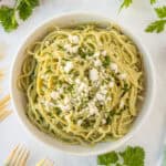Square image of Mexican Green Spaghetti topped with queso fresco and parsley