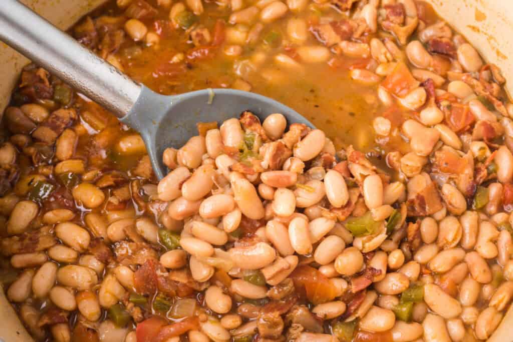 Close-up of Ranchero Beans with smoky bacon, tomatoes, and tender pinto beans