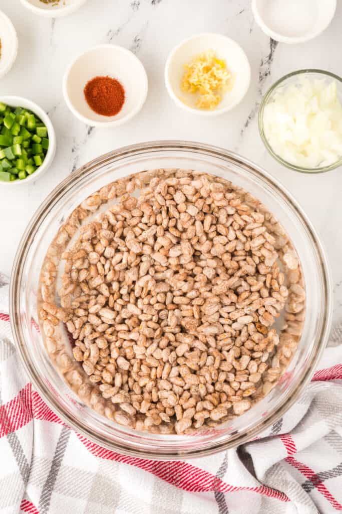 Dried pinto beans soaking in water for Ranchero Beans recipe