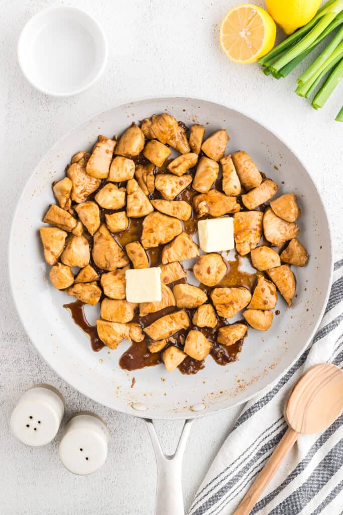 Butter added to skillet while finishing homemade Hibachi Chicken with rich Japanese steakhouse flavor.