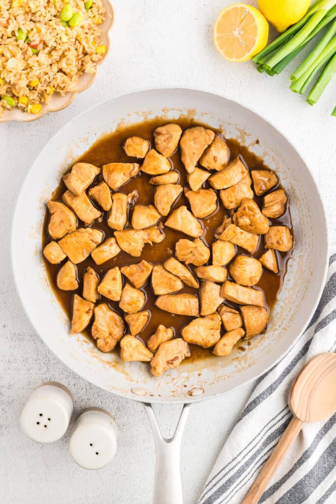 Finished Hibachi Chicken in buttery hibachi sauce served in a skillet with fried rice for an easy weeknight dinner.