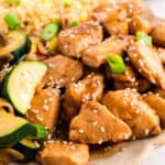 Square image of Hibachi Chicken with fried rice, zucchini, mushrooms, sesame seeds, and green onions for an easy Japanese steakhouse-style recipe.