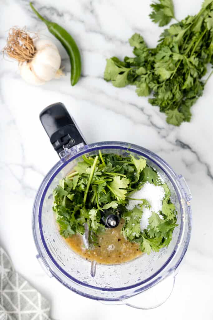 chopped cilantro, salt, and lime juice added to roasted vegetables in a food processor for Tomatillo Salsa