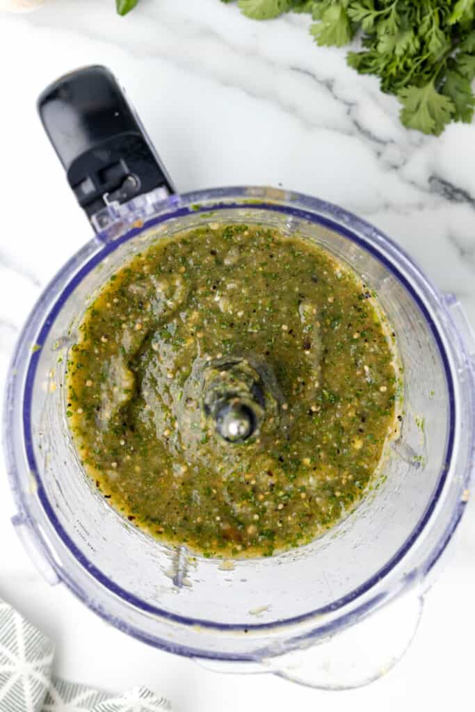 blended Tomatillo Salsa in a food processor showing a slightly chunky texture
