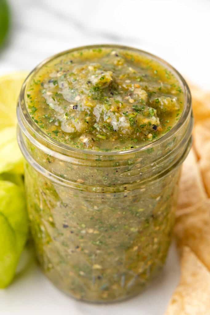 jar of Tomatillo Salsa with visible herbs and seeds