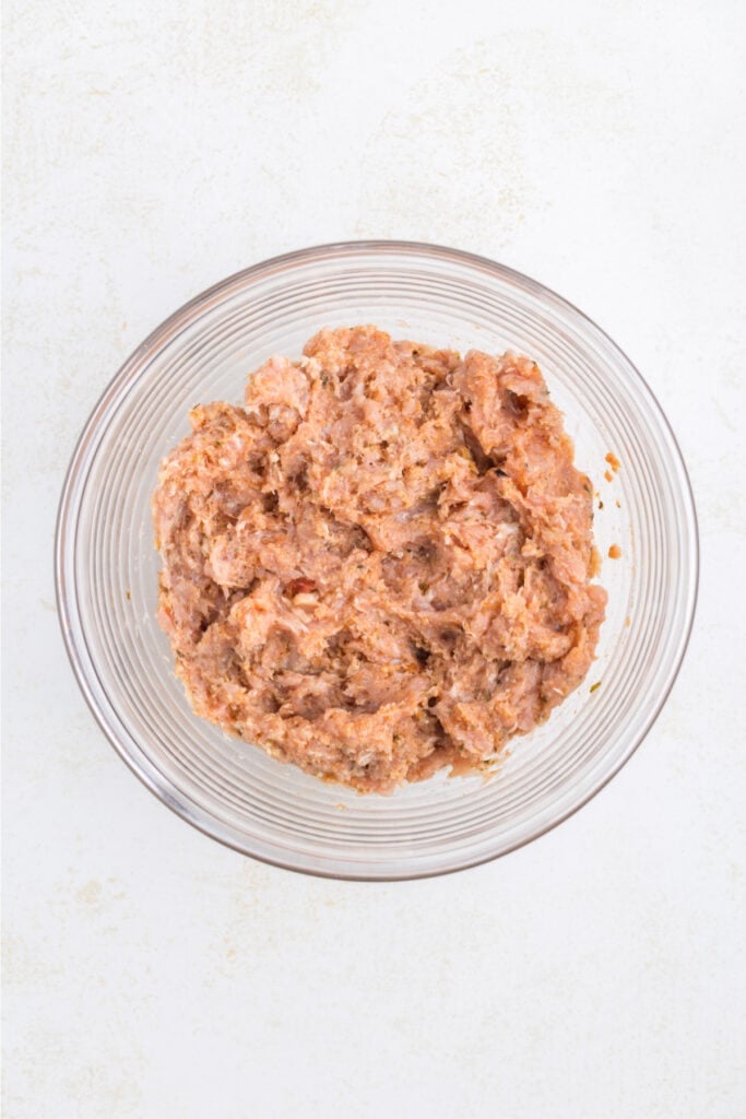 Chicken Parm Burger mixture combined in a glass mixing bowl