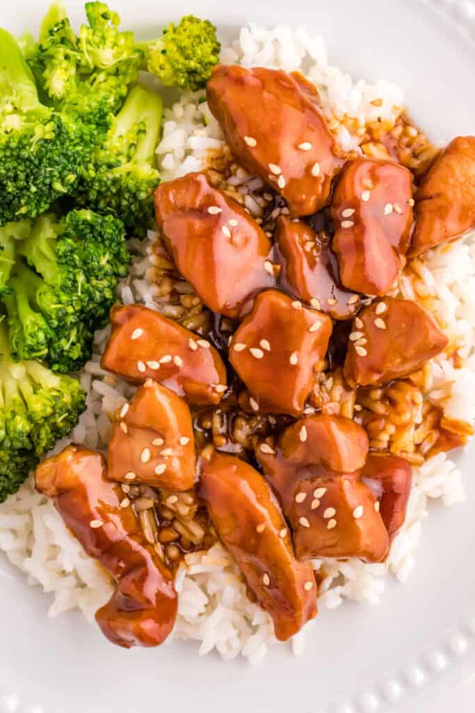 Close-up of Mongolian Pork served over rice with steamed broccoli