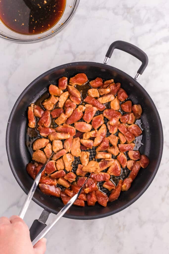 Pork browning in a skillet for homemade Mongolian Pork